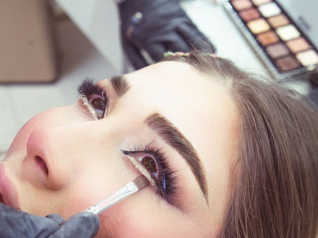 Close-up of eye makeup being applied during a client appointment