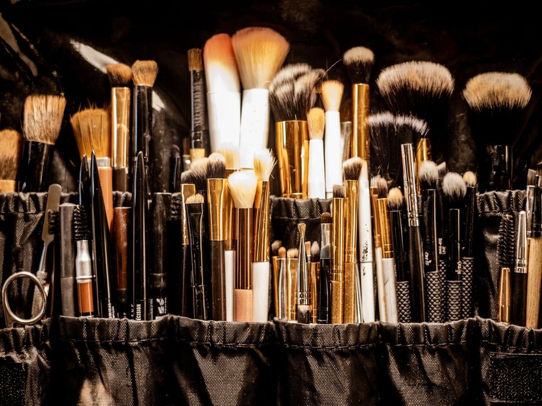 Professional makeup brush kit laid out before a booking