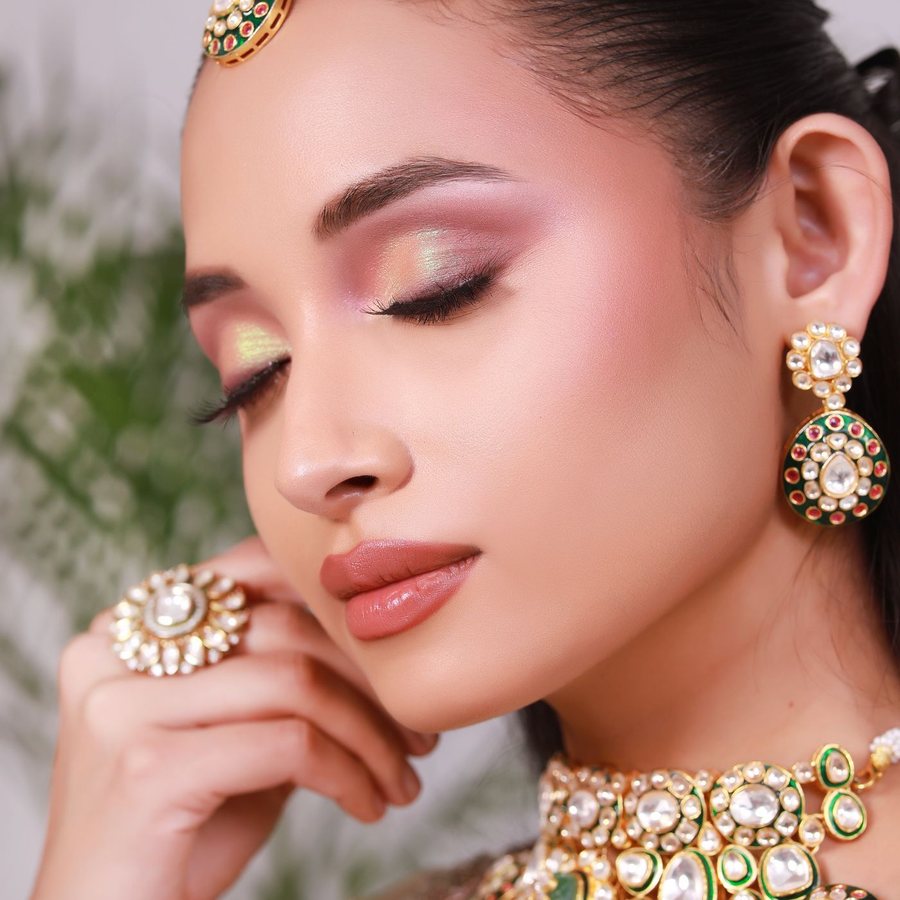 Close-up of a bride's soft rose-gold eye makeup and kundan earrings